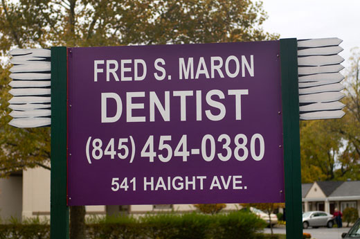 Large sign with toothbrushes for Dr. Maron’s dental office at the junction of routes 44 and 55